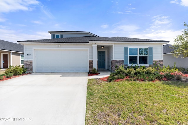 prairie-style home with a front yard and a garage