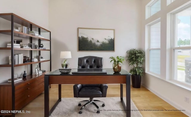 office space with light wood-type flooring and plenty of natural light