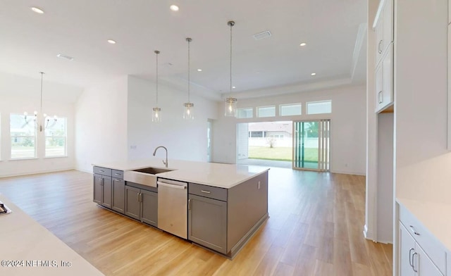 kitchen with gray cabinetry, decorative light fixtures, sink, and stainless steel dishwasher