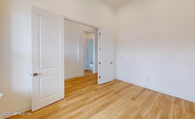 unfurnished bedroom featuring a closet and light hardwood / wood-style floors