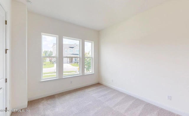 empty room with light colored carpet