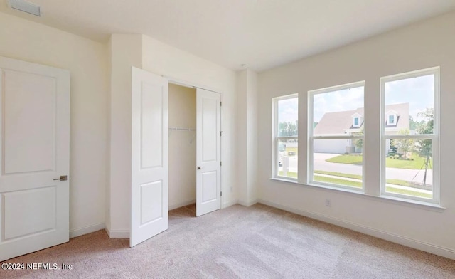 unfurnished bedroom featuring light carpet