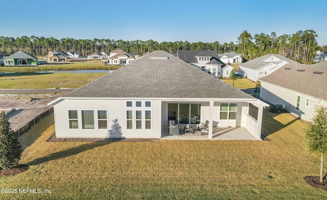 back of house featuring a lawn, outdoor lounge area, a water view, central AC unit, and a patio area