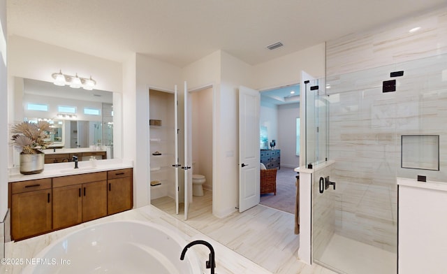 full bathroom with plus walk in shower, vanity, and toilet