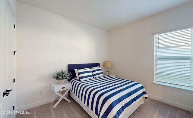 bedroom featuring multiple windows and light colored carpet