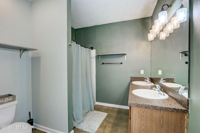 bathroom with tile flooring, toilet, and dual bowl vanity