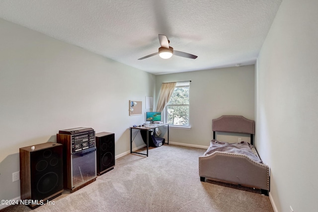 interior space with light carpet, ceiling fan, and a textured ceiling