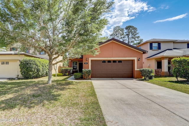 view of front of home with a garage and a front lawn