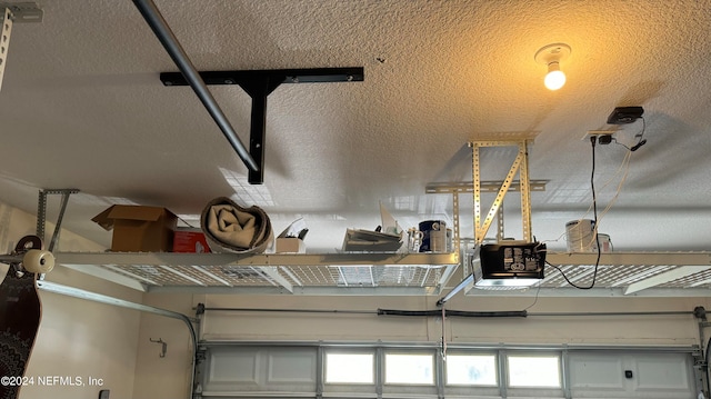 interior details featuring a textured ceiling and a garage door opener