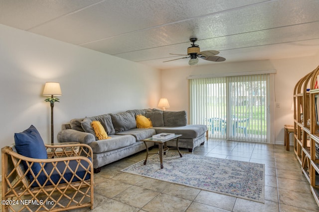 tiled living room featuring ceiling fan and a textured ceiling