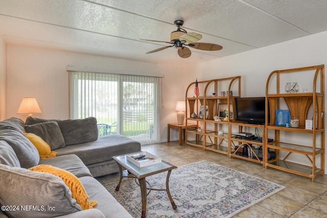 tiled living room with a textured ceiling and ceiling fan