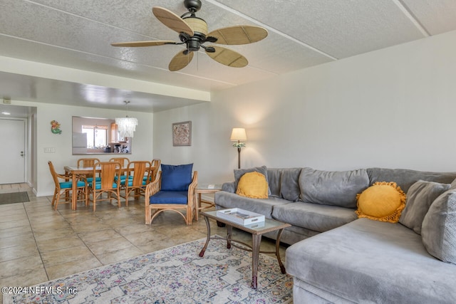 tiled living room featuring a textured ceiling and ceiling fan with notable chandelier