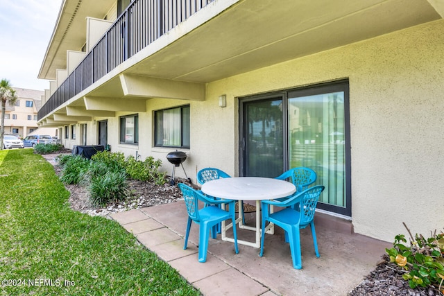 view of patio featuring a balcony