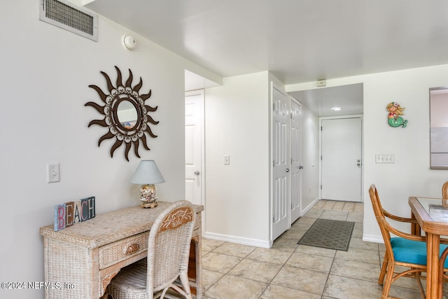 dining space featuring light tile floors