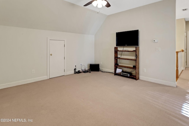 additional living space featuring ceiling fan, vaulted ceiling, and light colored carpet
