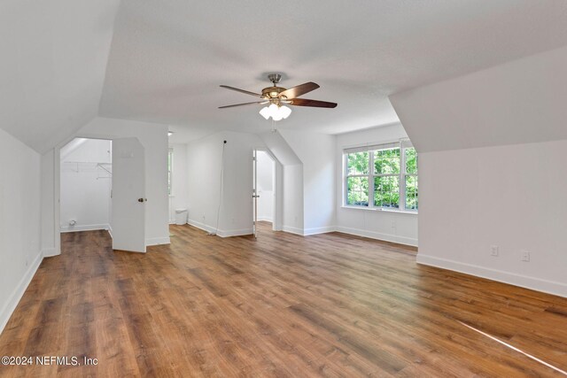 bonus room featuring dark hardwood / wood-style floors, ceiling fan, and vaulted ceiling