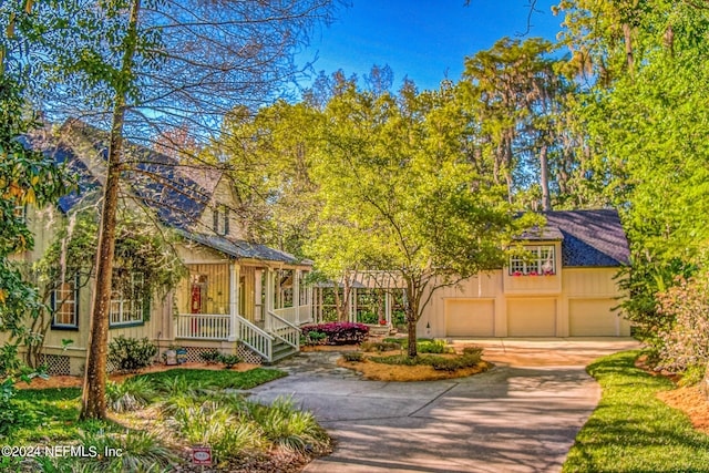view of front of house featuring a porch and a garage