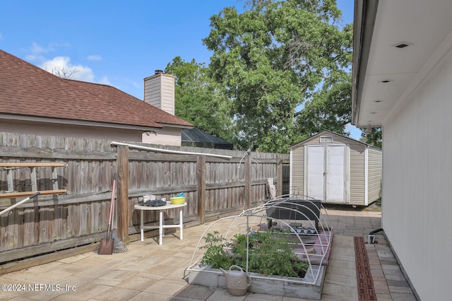 view of patio / terrace featuring a storage shed