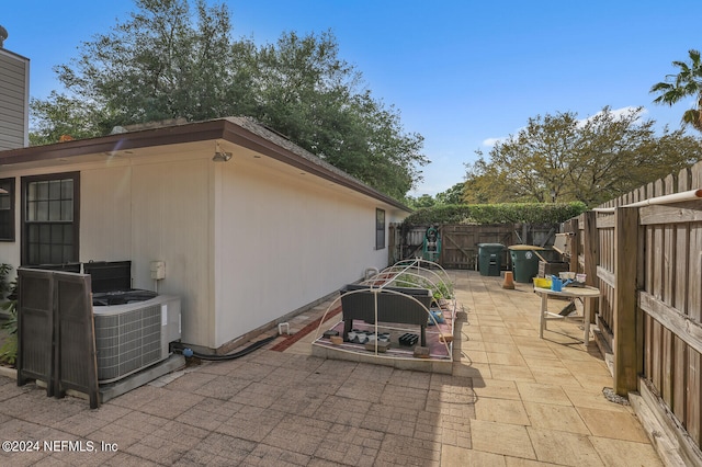 view of side of property featuring a patio and cooling unit