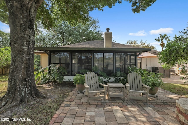 view of patio featuring a sunroom