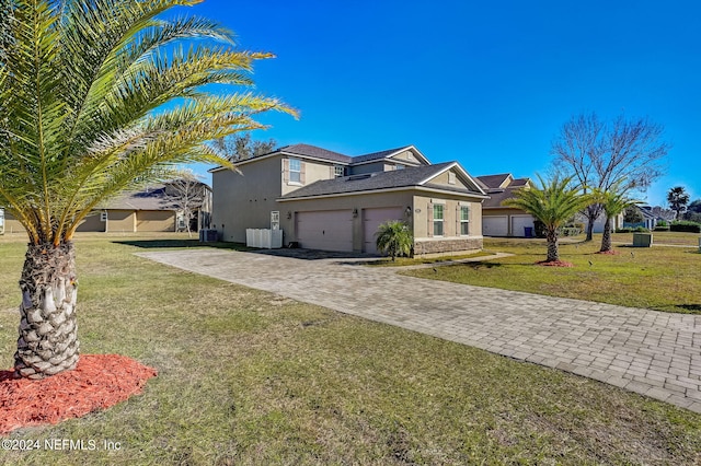 view of front facade featuring central AC unit, a front lawn, and a garage