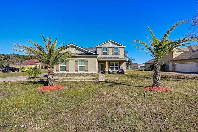 view of front of property with a front lawn and a garage