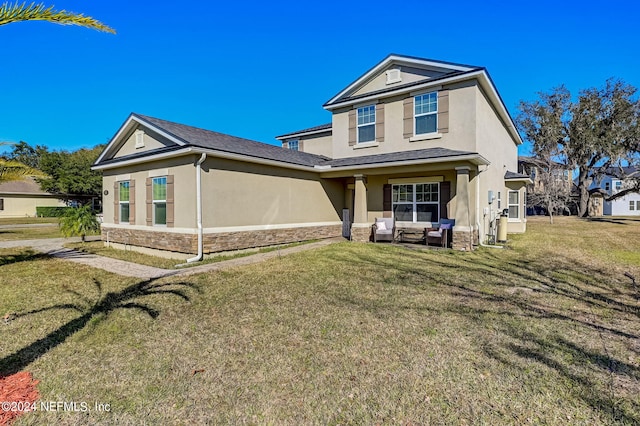 view of front of home with an outdoor living space, a front yard, and a patio