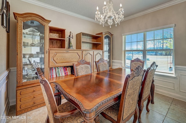 dining room with crown molding, a notable chandelier, and light tile floors