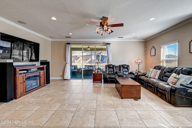 living room featuring light tile floors, ornamental molding, ceiling fan, and a textured ceiling