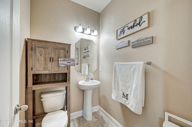 bathroom with tile floors and toilet