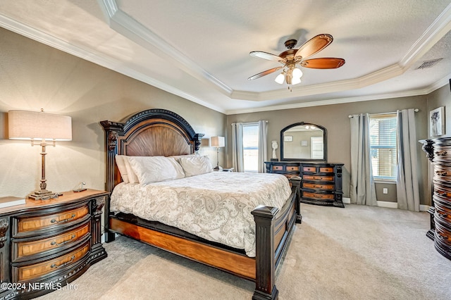 bedroom featuring ceiling fan, crown molding, a raised ceiling, and light colored carpet