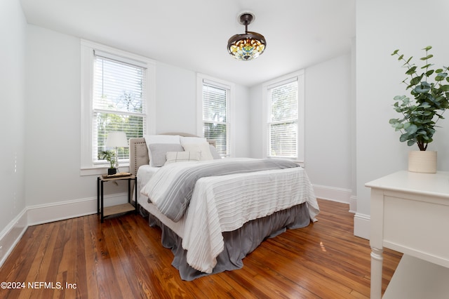 bedroom with dark wood-type flooring