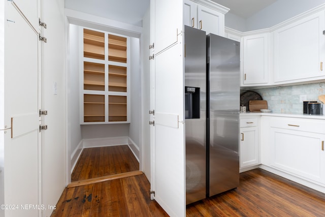 kitchen with stainless steel fridge with ice dispenser, white cabinetry, dark hardwood / wood-style floors, and tasteful backsplash