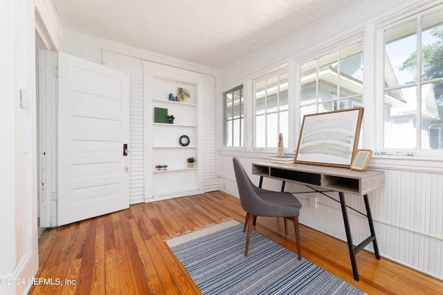 home office featuring dark wood-type flooring and a wealth of natural light