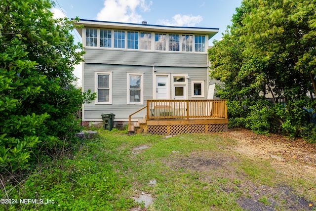 back of property featuring a deck