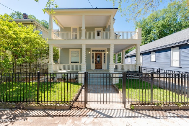 view of front of house with a porch and a front yard