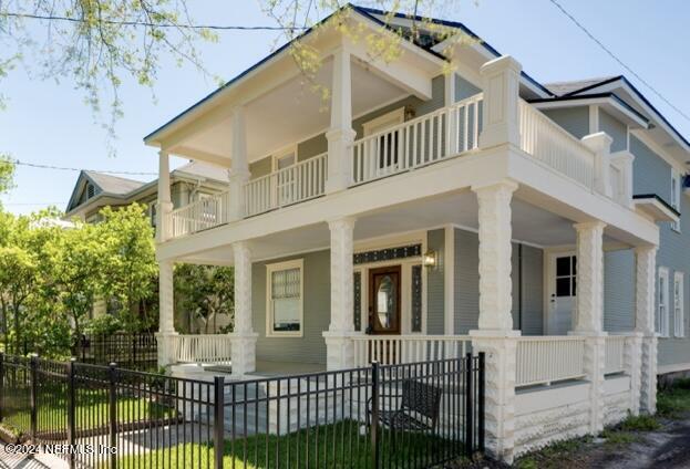 view of front facade featuring a balcony and covered porch