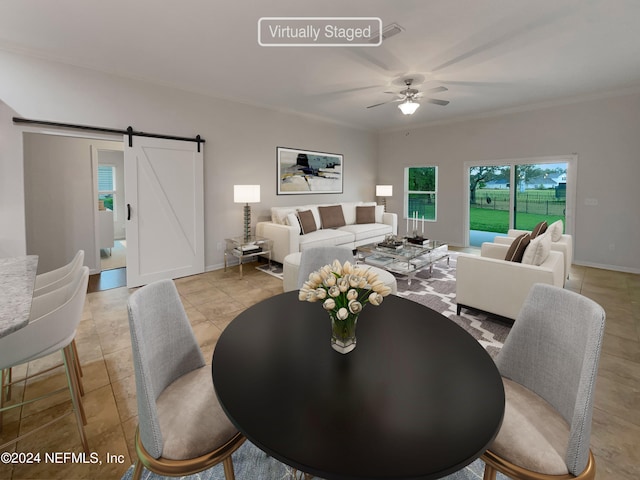 dining room featuring a barn door, light tile floors, ceiling fan, and crown molding