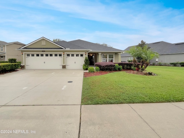 view of front of house featuring a front lawn and a garage