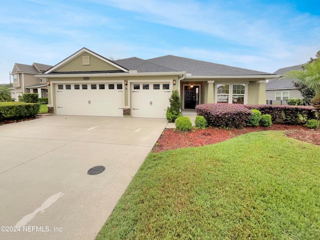 view of front of home featuring a front lawn and a garage