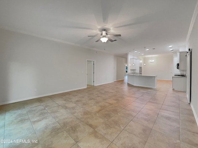 unfurnished living room with a barn door, ceiling fan, light tile flooring, and ornamental molding