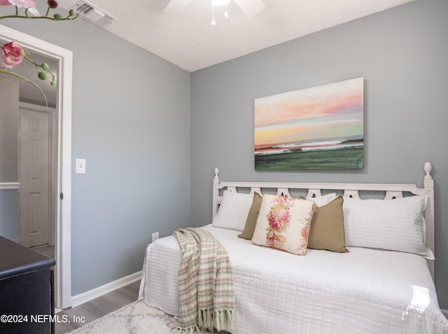 bedroom with ceiling fan and hardwood / wood-style floors