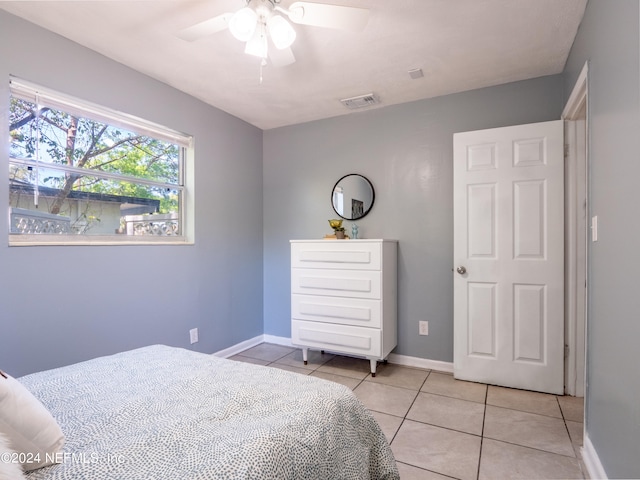 bedroom with ceiling fan and light tile patterned floors