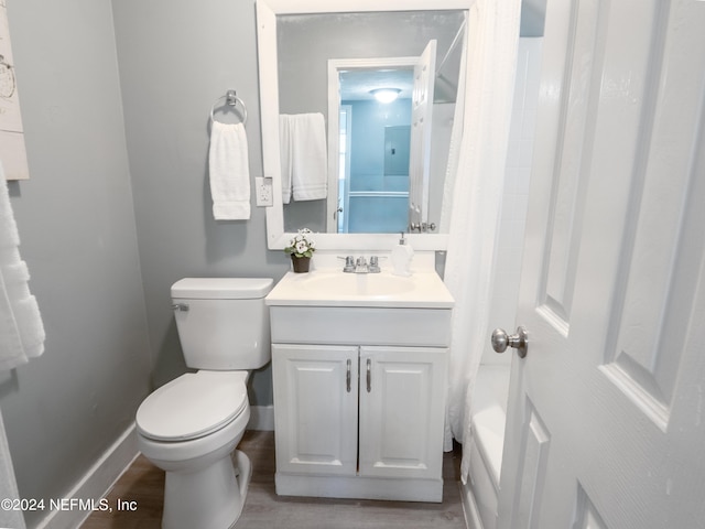 bathroom with toilet, wood-type flooring, and vanity