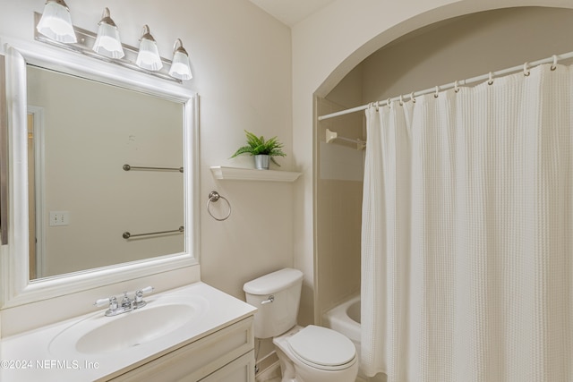 full bathroom featuring shower / bathtub combination with curtain, vanity, and toilet