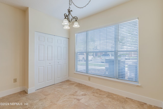 unfurnished dining area with an inviting chandelier and a wealth of natural light