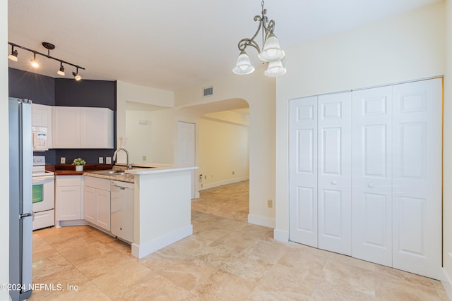 kitchen with pendant lighting, sink, white cabinets, kitchen peninsula, and white appliances