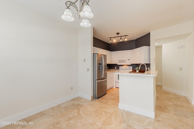 kitchen with white cabinets, white appliances, pendant lighting, track lighting, and a notable chandelier