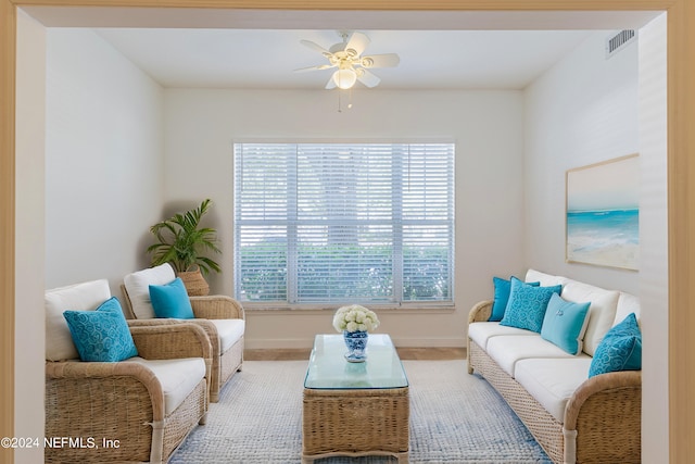 living room featuring carpet and ceiling fan