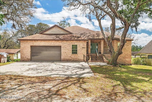 ranch-style house with a front yard and a garage